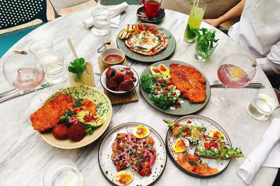 A table with six plates of food on it