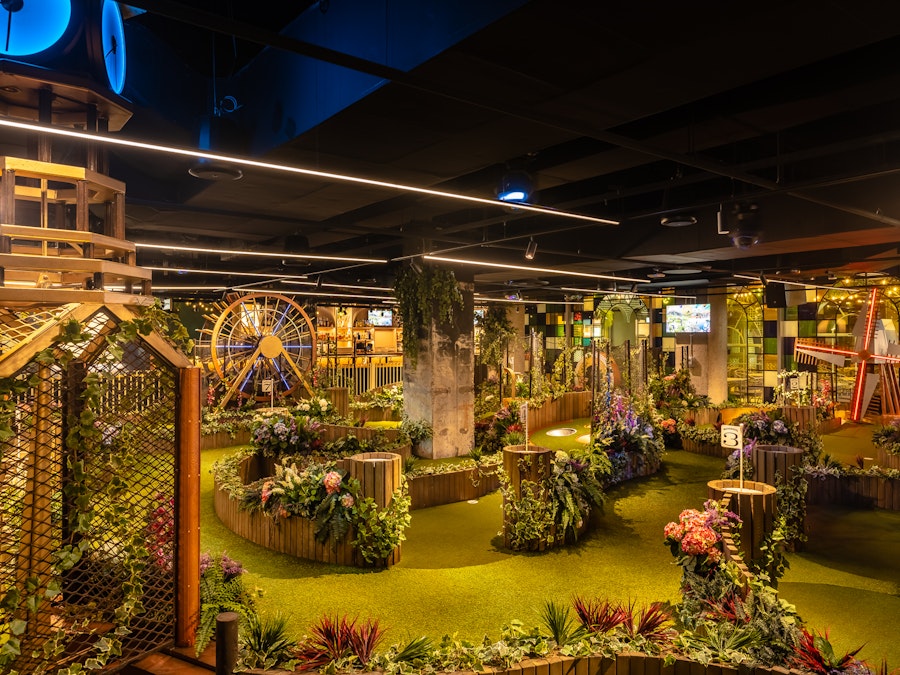 empty indoor mini golf course at night