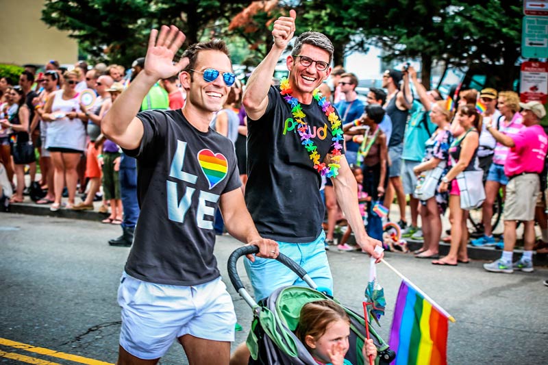 Couple walking with child during Capital Pride Parade - LGBTQ Summer Events in Washington, DC