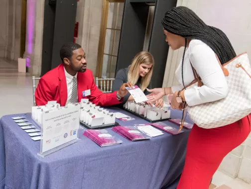 Destination DC staffing services redcoat providing assistance at registration to an event attendee in Washington, DC