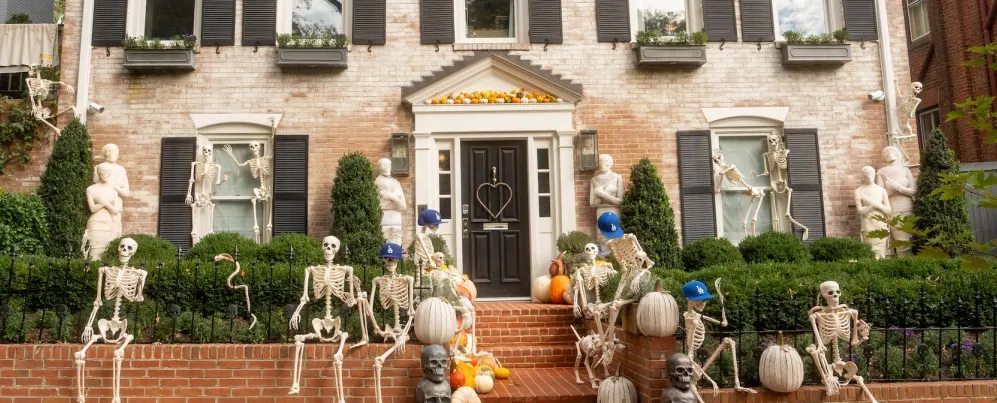 Skeletons and pumpkins decorate the front of a historic home in Georgetown. 