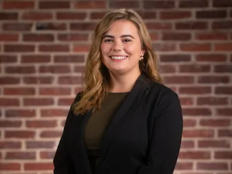 A person smiles for a professional portrait. 